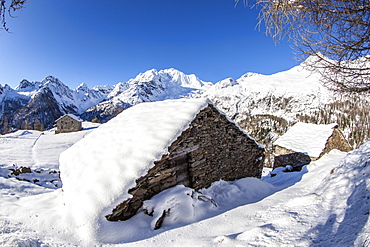 Hut covered with snow with Monte Disgrazia on background, Alpe dell'Oro, Valmalenco, Valtellina, Lombardy, Italy, Europe