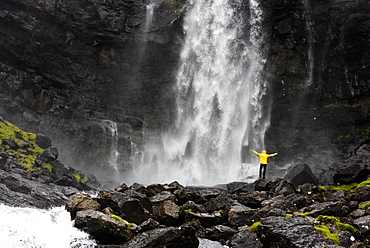 Hiker at Fossa waterfall, Streymoy island, Faroe Islands, Denmark, Europe