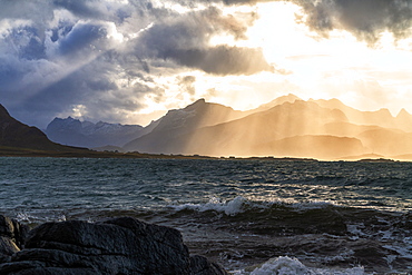 Sun rays above the rough sea of Flakstadoya seen from Vareid, Nordland, Lofoten Islands, Norway, Europe