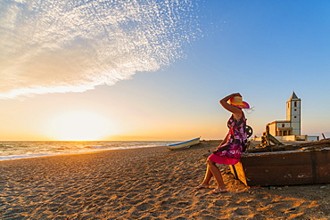 Woman on Iglesia de Las Salinas beach at sunset in Cabo de Gata-Nijar Natural Park, Spain, Europe