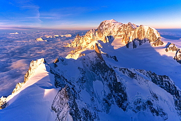 Aerial view of snowy peaks of Mont Blanc and Dent du Geant during sunrise, Courmayeur, Aosta Valley, Italy, Europe