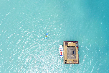 Aerial view by drone of man on paddleboard approaching the floating Ocean Bar, Caribbean, Antilles, West Indies, Caribbean, Central America