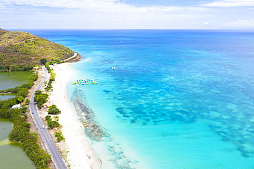 Aerial view by drone of coastal road beside white sand beach, Caribbean, Antilles, West Indies, Caribbean, Central America