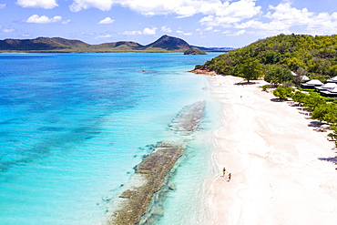 Aerial view by drone of man and woman running on white sand beach, Antilles, West Indies, Caribbean, Central America