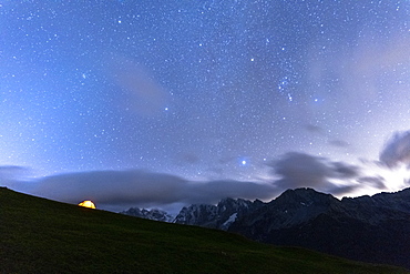 Camping tent under the stars facing Piz Badile and Piz Cengalo, Tombal, Soglio, Val Bregaglia, Canton of Graubunden, Switzerland, Europe