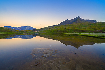 Silhouettes of mountains mirrored in Lago Bianco at dawn, Gavia Pass, Valfurva, Valtellina, Sondrio province, Lombardy, Italy, Europe