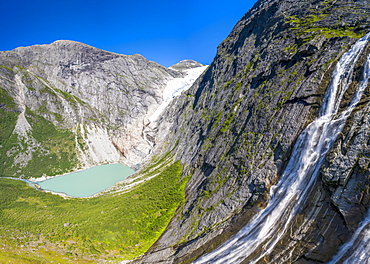 Aerial panoramic by drone of waterfall above Briksdalsbreen glacier, Loen, Jostedalsbreen National Park, Sogn og Fjordane, Norway, Scandinavia, Europe