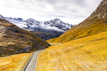 View by drone of scenic road in the autumnal landscape towards Cresta Di Reit, Braulio Valley, Bormio, Valtellina, Lombardy, Italy, Europe