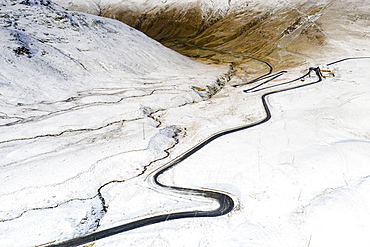 Aerial view by drone of S-shape road towards Stelvio Pass in the snowy landscape, Bormio, Sondrio province, Valtellina, Lombardy, Italy, Europe