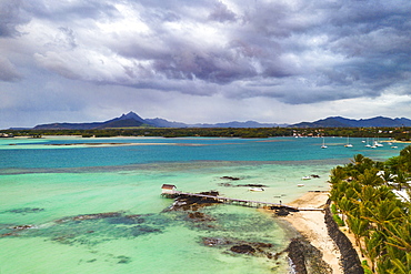 Clouds over lagoon and pier by a palm fringed beach, aerial view, Trou d'Eau Douce, Flacq, East coast, Mauritius, Indian Ocean, Africa