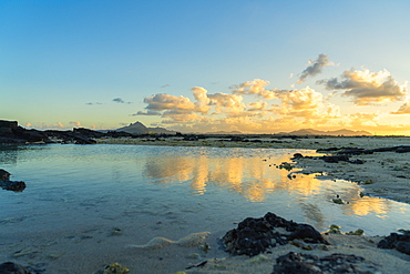 Clouds mirrored in the calm water of the Indian Ocean at sunset, Trou d'Eau Douce, Flacq district, East coast, Mauritius, Africa