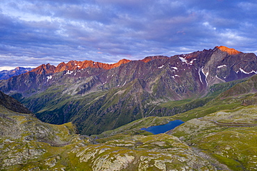 Aerial panoramic of Cima di Pietrarossa and Lago Nero at dawn, Gavia Pass, Valcamonica, Lombardy, Italy, Europe