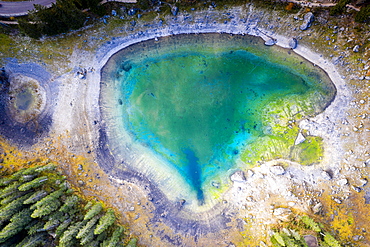 Aerial view by drone of heart shaped Carezza Lake, Dolomites, South Tyrol, Italy, Europe