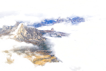 Aerial view by drone of Ra Gusela and Cinque Torri mountains covered by clouds and fog in autumn, Giau Pass, Dolomites, Belluno, Veneto, Italy, Europe