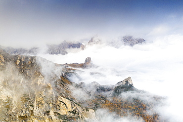 Aerial view of autumn mist over the trees and woods surrounding Cinque Torri and Tofane, Giau Pass, Dolomites, Belluno, Veneto, Italy, Europe