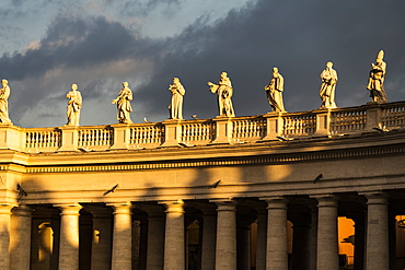 Statues of St. Peter's Square colonnade lit by sunrise, Vatican City, UNESCO World Heritage Site, Rome, Lazio, Italy, Europe