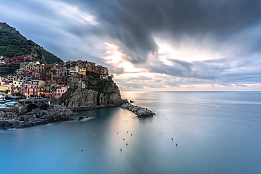 Storm clouds at sunrise over Manarola and Ligurian Sea, Cinque Terre, UNESCO World Heritage Site, La Spezia province, Liguria, Italy, Europe