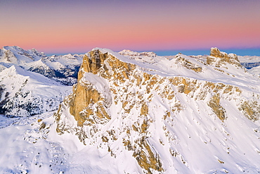 View by drone of pink sky at sunrise on Ra Gusela, Nuvolau, Averau, Marmolada covered with snow, Dolomites, Belluno, Veneto, Italy, Europe