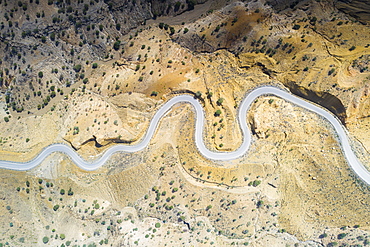 Aerial view by drone of hairpin bends of empty road along Danakil desert from above, Afar Region, Ethiopia, Africa