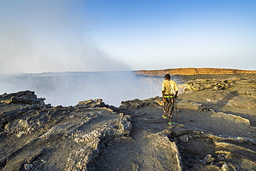 Afar man looking down to Erta Ale volcano caldera, Danakil Depression, Afar Region, Ethiopia, Africa