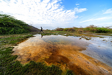 Afar man walking close to a geyser, Semera, Afar Region, Ethiopia, Africa