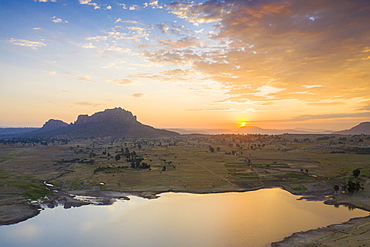 Sunrise lighting the small lake and Gheralta Mountains in background, aerial view by drone, Dugem, Tigray Region, Ethiopia, Africa