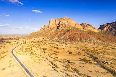 Road crossing the desert landscape of Gheralta Mountains at sunset, aerial view by drone, Hawzen, Tigray Region, Ethiopia, Africa