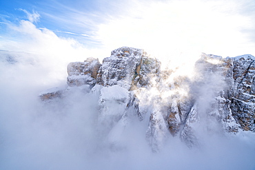 Mist over the snowy peaks of Sella Group, Dolomites, South Tyrol, Italy, Europe