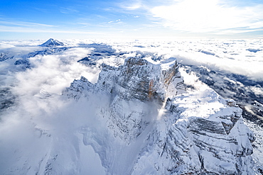 Snow capped Monte Pelmo emerging from clouds, aerial view, Dolomites, Belluno province, Veneto, Italy, Europe