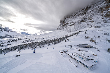 Clouds over the snowy slopes of Sella Pass ski area, Val Gardena, Dolomites, Trentino-Alto Adige, Italy, Europe