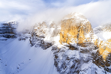 Mist over the rocky peaks of Sella Group during a snowy winter, Gardena Pass, Dolomites, Trentino-Alto Adige, Italy, Europe