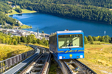 Funicular car uphill with St. Moritz lake and village in the background, Engadine, canton of Graubunden, Switzerland, Europe