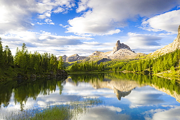 Clouds over Becco di Mezzodi reflected in the blue water of Lake Federa at sunrise, Ampezzo Dolomites, Belluno, Veneto, Italy, Europe