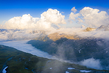 Sunlight over mountains in the fog, aerial view, Furka Pass, Canton Uri, Switzerland, Europe