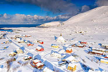 Aerial view of the fishing village of Hasvik covered with snow in winter, Soroya Island, Troms og Finnmark, Northern Norway, Scandinavia, Europe