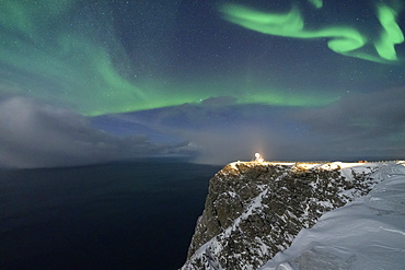 Northern Lights (Aurora Borealis) over North Cape cliff in winter, Mageroya island, Barents Sea, Troms og Finnmark, Northern Norway, Scandinavia, Europe