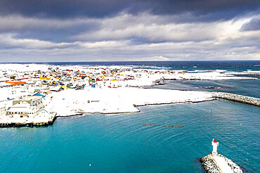 Storm clouds over lighthouse and Berlevag village covered with snow, Barents Sea, Varanger Peninsula, Troms og Finnmark, Norway, Scandinavia, Europe