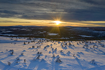 Arctic sunset over the snowy forest and ski area of Levi, Sirkka, Kittila municipality, Lapland, Finland, Europe