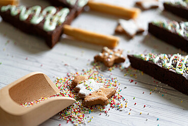 Homemade cookie in shape of Christmas tree and chocolate brownies decorated with sugar balls, Italy, Europe