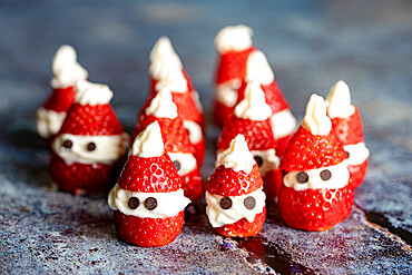 Decorated cute little strawberries in shape of Santa Claus filled with with whipped cream at Christmas, Italy, Europe