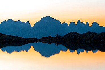 Brenta Dolomites mountains reflected in pristine water of Lago Nero di Cornisello at sunrise, Trentino-Alto Adige, Italy, Europe