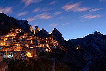 Illuminated village of Castelmezzano framed by Dolomiti Lucane peaks at sunrise, Potenza province, Basilicata, Italy, Europe