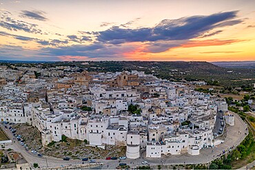 Aerial panoramic of white buildings in the old town of Ostuni at sunset, province of Brindisi, Salento, Apulia, Italy, Europe