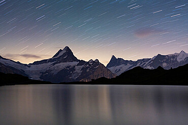 Star trail in the night sky over Bachalpsee lake, Grindelwald, Bernese Oberland, Canton of Bern, Switzerland, Europe