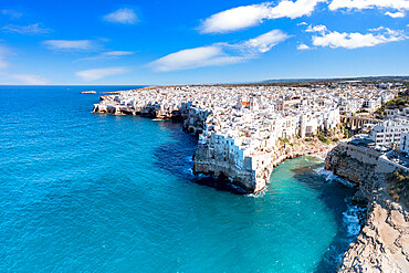 Aerial view of crystal sea surrounding Polignano a Mare on cliffs, province of Bari, Apulia, Italy, Europe