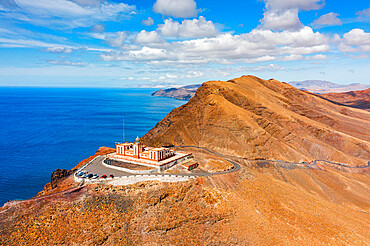 Desert mountain landscape surrounding Entallada lighthouse overlooking the ocean, Fuerteventura, Canary Islands, Spain, Atlantic, Europe