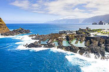 Natural pools formed by volcanic lava filled with crystal-clear sea water, Porto Moniz, Madeira island, Portugal, Atlantic, Europe