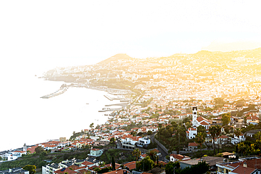 Mist at sunset over Funchal Bay and city viewed from Sao Goncalo, Madeira island, Portugal, Atlantic, Europe