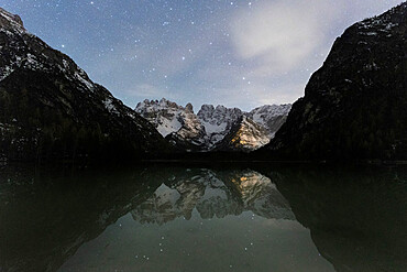 Starry sky over Cristallo group mountains reflected in Lake Landro, Dolomites, Bolzano province, South Tyrol, Italy, Europe