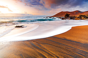 Foam of sea waves on golden sand beach at sunset, Playa de la Solapa, Pajara, Fuerteventura, Canary Islands, Spain, Atlantic, Europe